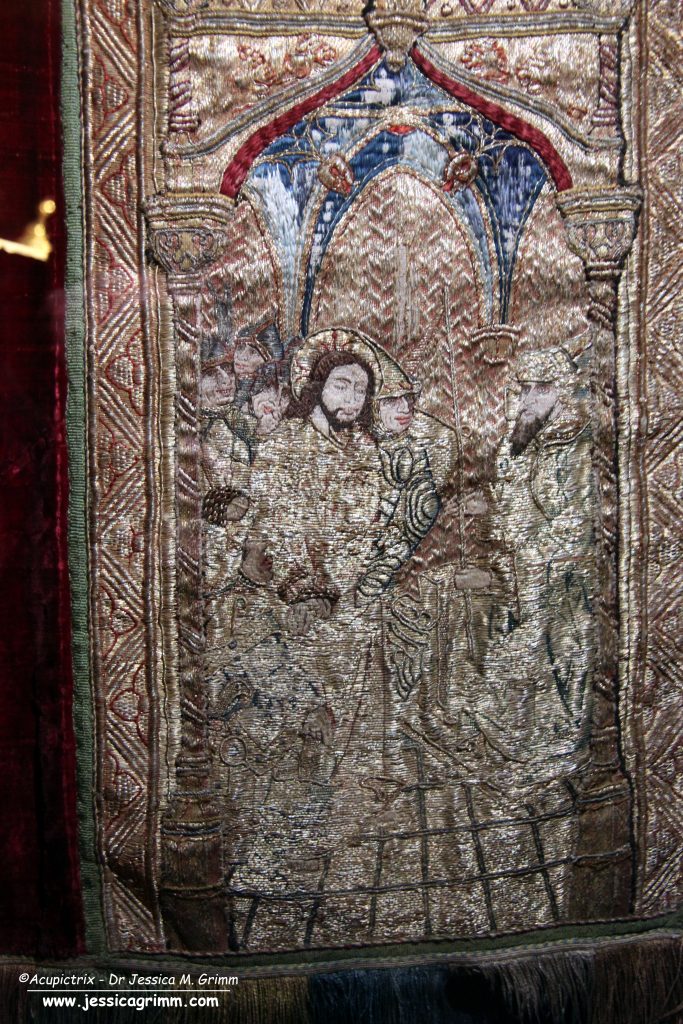 Goldwork orphrey on a red late medieval vestments.