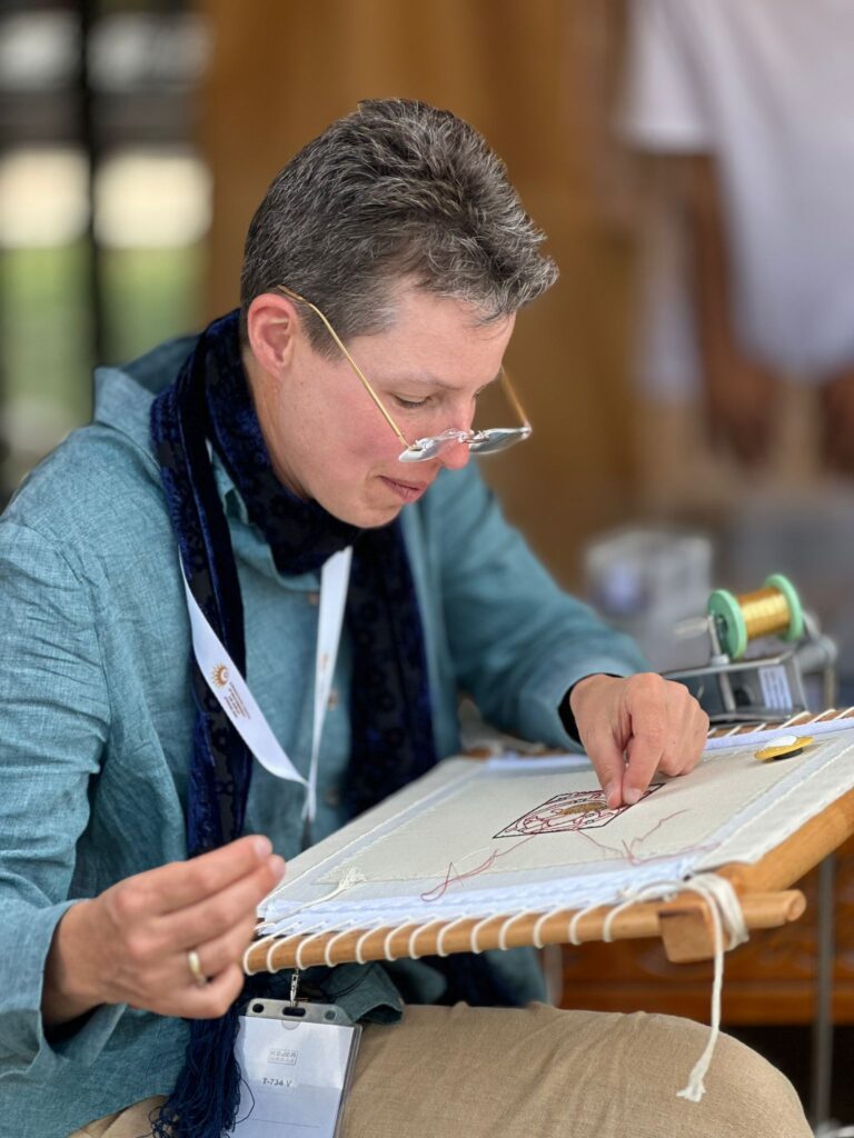 Acupictrix - Dr Jessica Grimm working Medieval Goldwork Embroidery on her slate frame in Uzbekistan.