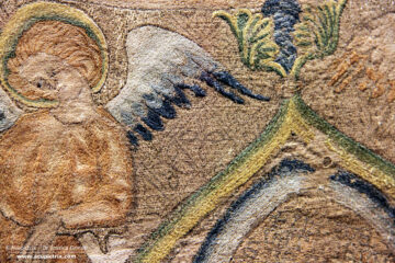 Opus anglicanum - an embroidered multi-coloured cope on display in a museum.