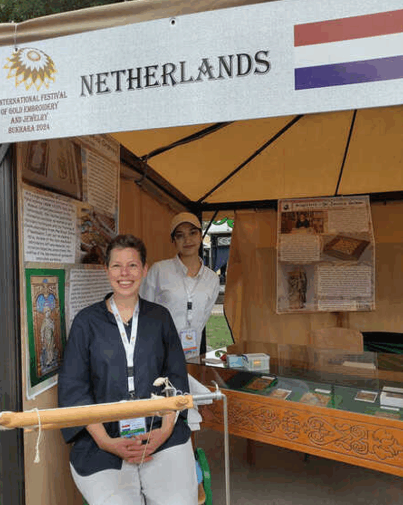 Dr Jessica Grimm and volunteer Shaxina in front of the Dutch booth at the International Festival of Gold Embroidery, Bukhara, Uzbekistan