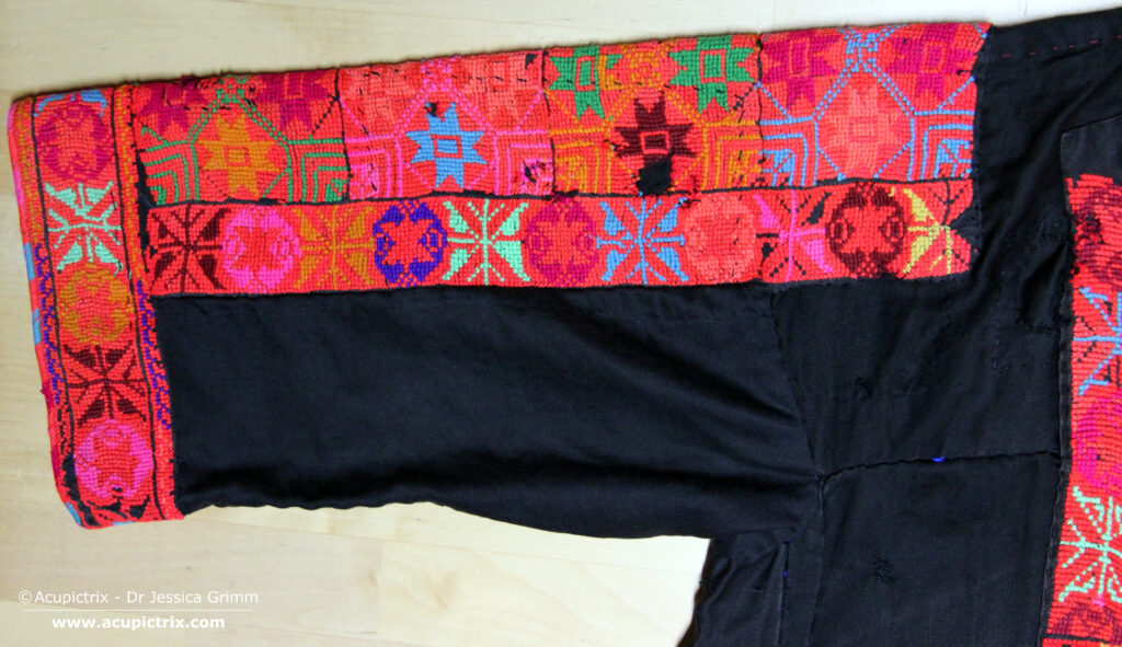 Fallahi embroidery - black Bedouin dress with colourful crossstitch embroidery