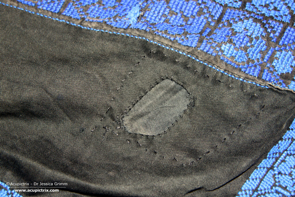 Fallahi embroidery - black Bedouin dress with colourful crossstitch embroidery