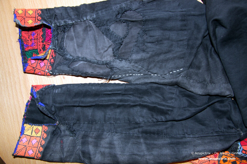 Fallahi embroidery - black Bedouin dress with colourful crossstitch embroidery