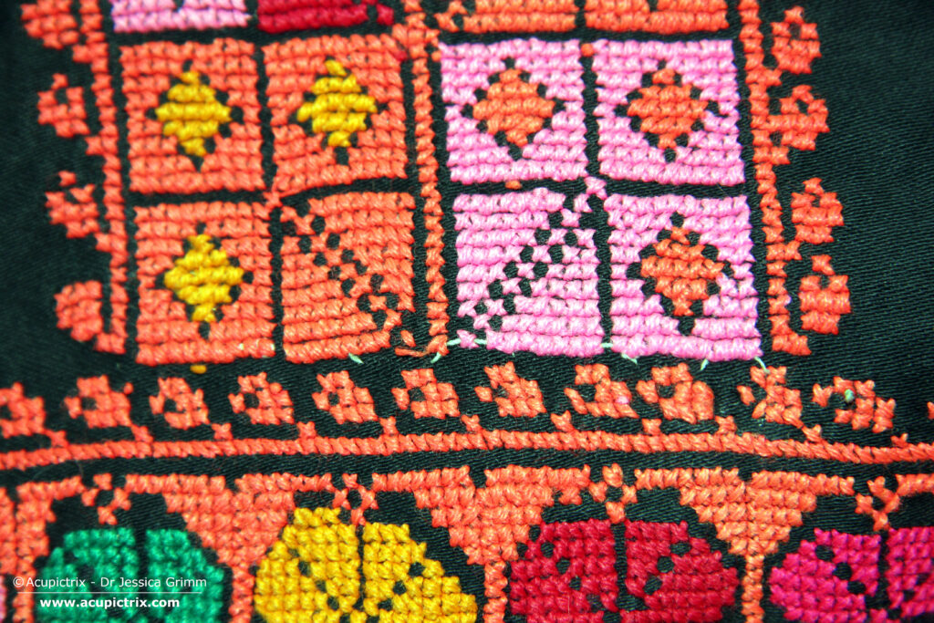 Fallahi embroidery - black Bedouin dress with colourful crossstitch embroidery