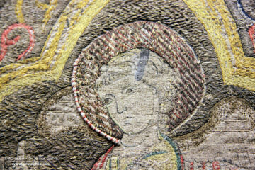 Opus romanum - multi coloured embroidery showing the nimbed head of an angel